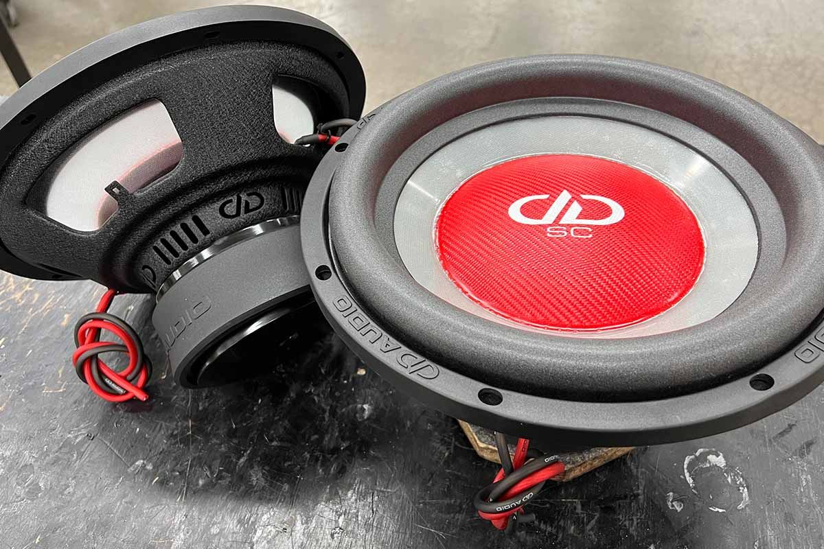USA Made Subwoofers with ghost cones, red carbon fiber dust cap, white DDA logo and white Super Charged decal - on shot from the top, the other from the bottom to show translucent properties