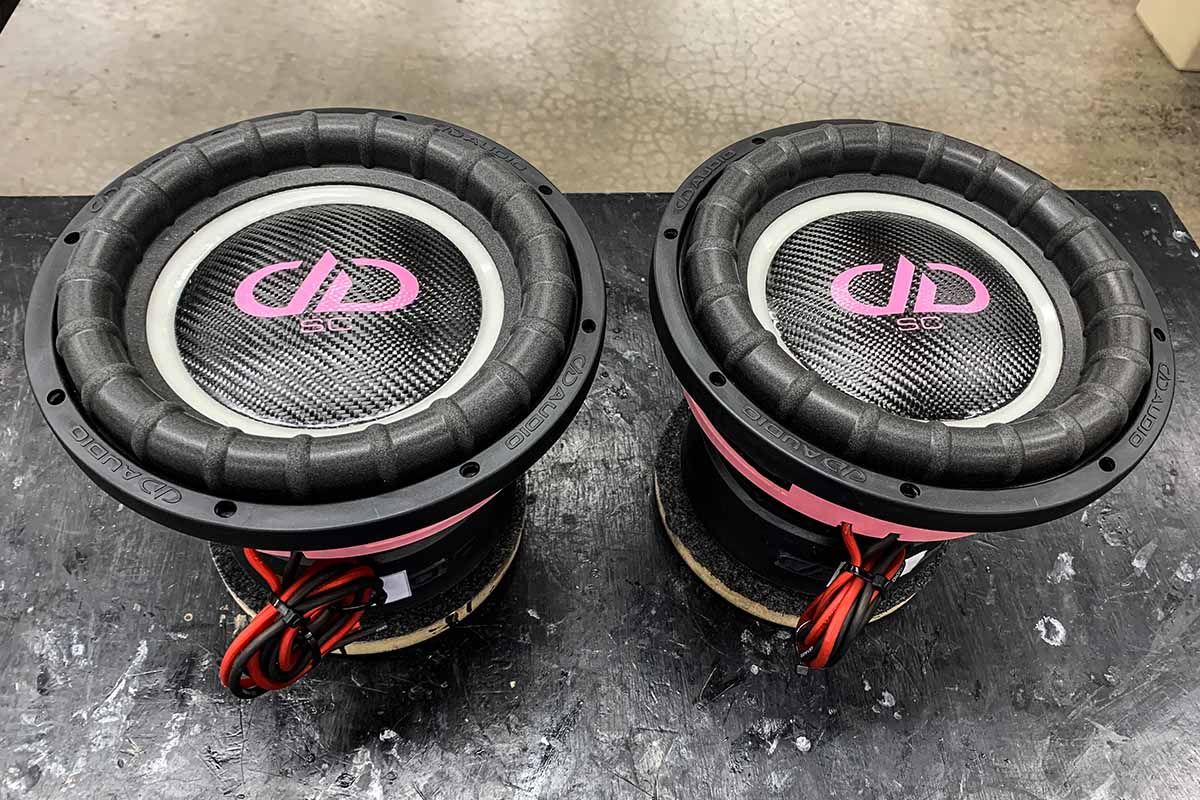 USA Made Subwoofers with ghost cones, black carbon fiber dust caps, pink DDA logos and pink super charged decals