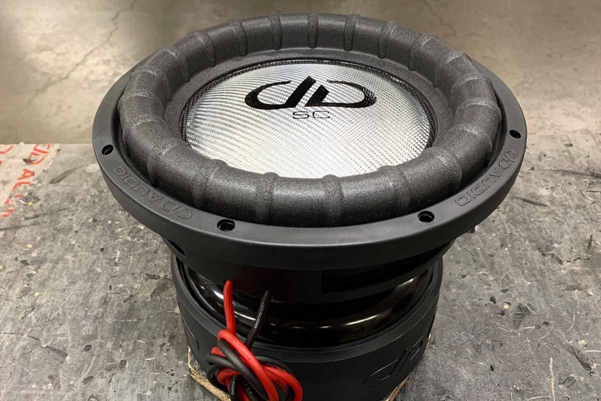 USA Made subwoofer with silver dust cap and black DDA logo and super charged decal