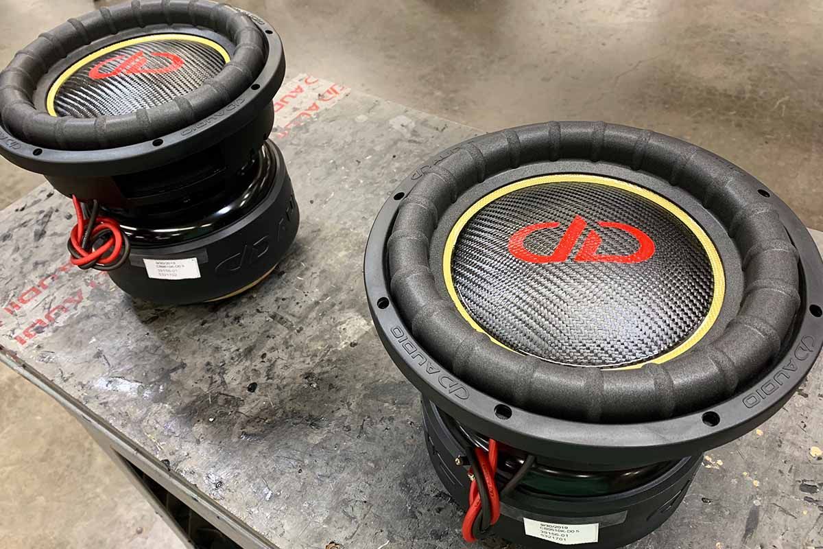 Two USA Made subwoofers with yellow cones, black dust caps, and red DDA logos