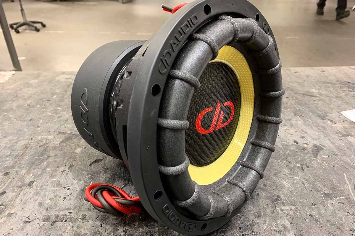 USA Made Subwoofers with black carbon fiber dust cap, yellow cone, and red DDA logo