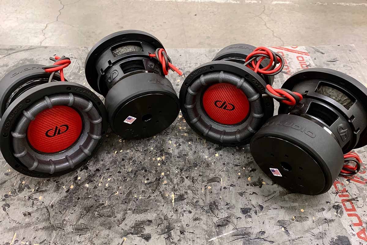 Four USA Made subwoofers with red carbon fiber dust caps and black DDA logos