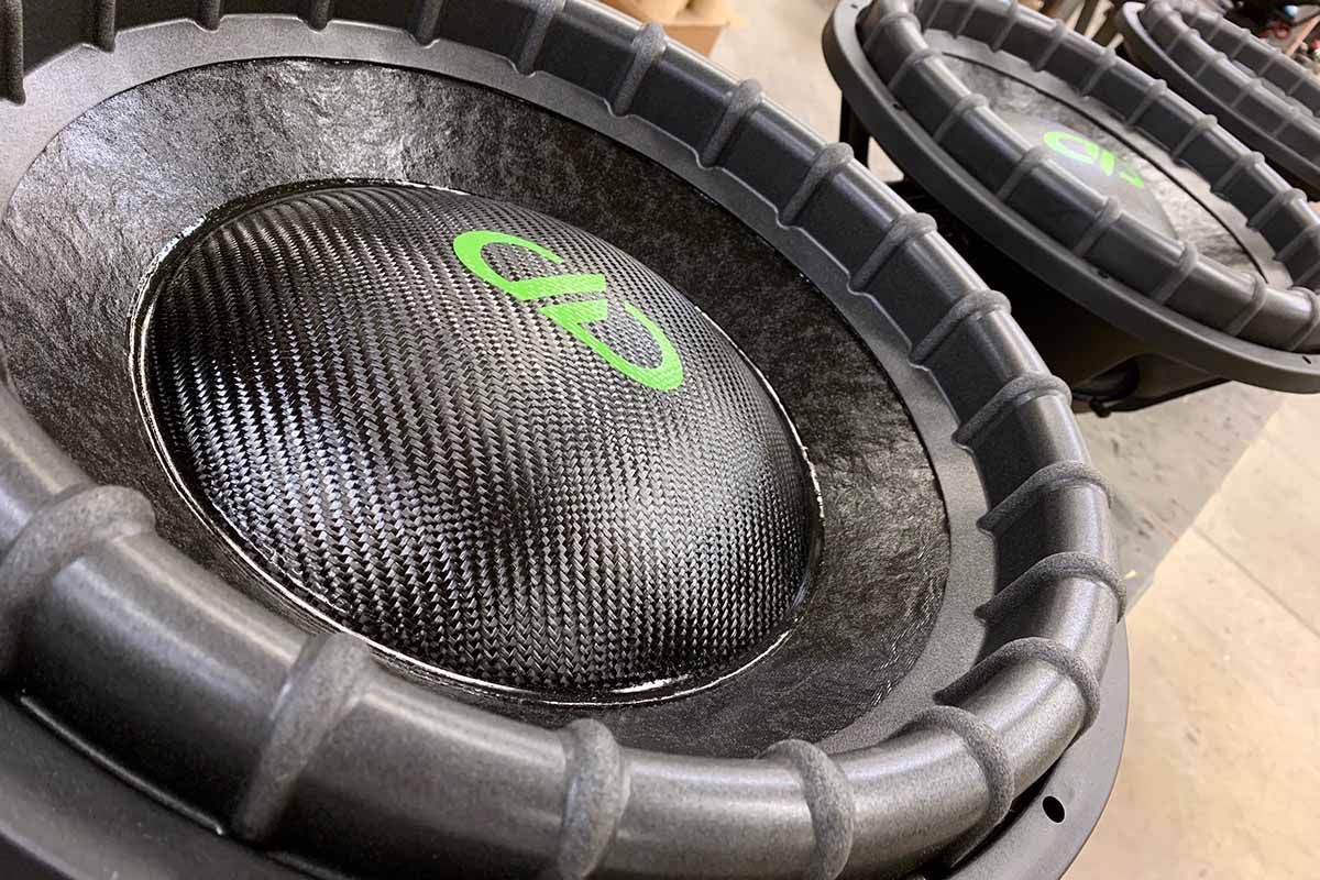 Three USA Made Subwoofers with black cone and black carbon fiber dust cap with lime green DDA logo