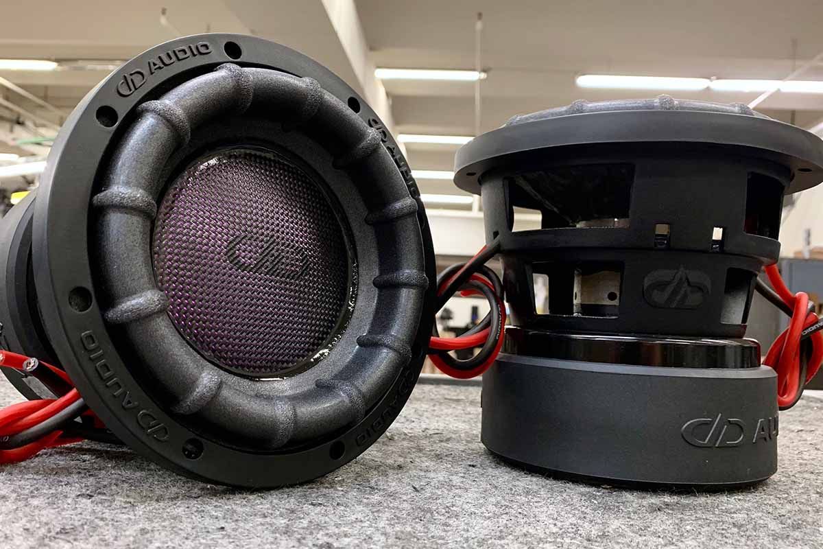 Two USA Made subwoofers with purple polychromatic dust caps and black DDA logo