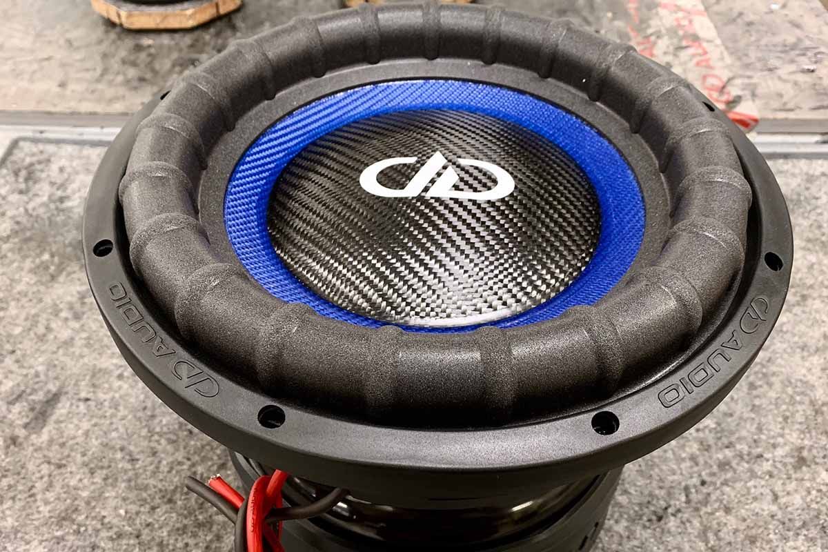 USA Made subwoofer with electric blue cone, black carbon fiber dust cap and white DDA logo