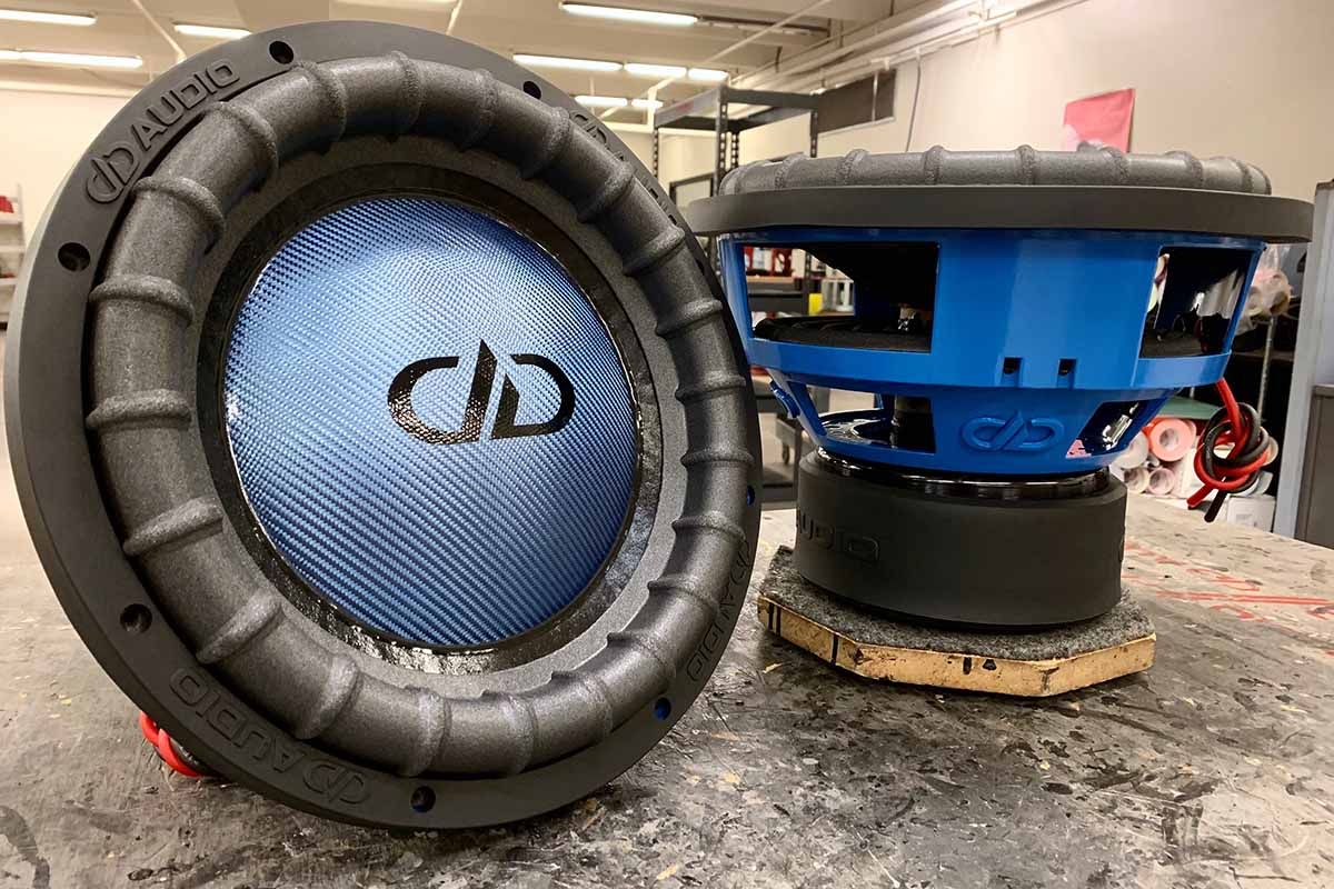 Two USA Made subwoofer with blue powder coat baskets, blue carbon fiber dust caps, black DDA logos