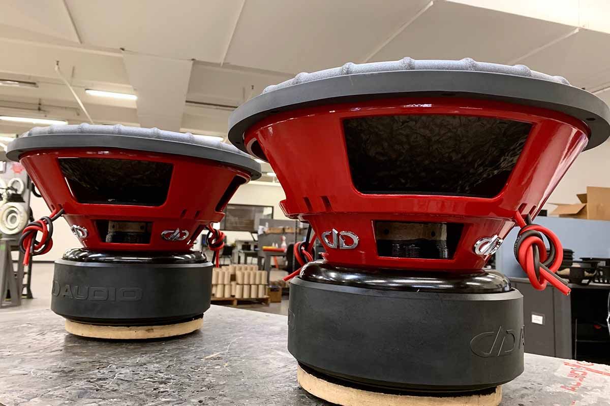 Two USA Made subwoofers with red powder coat baskets and polished chrome DDA embossed logos