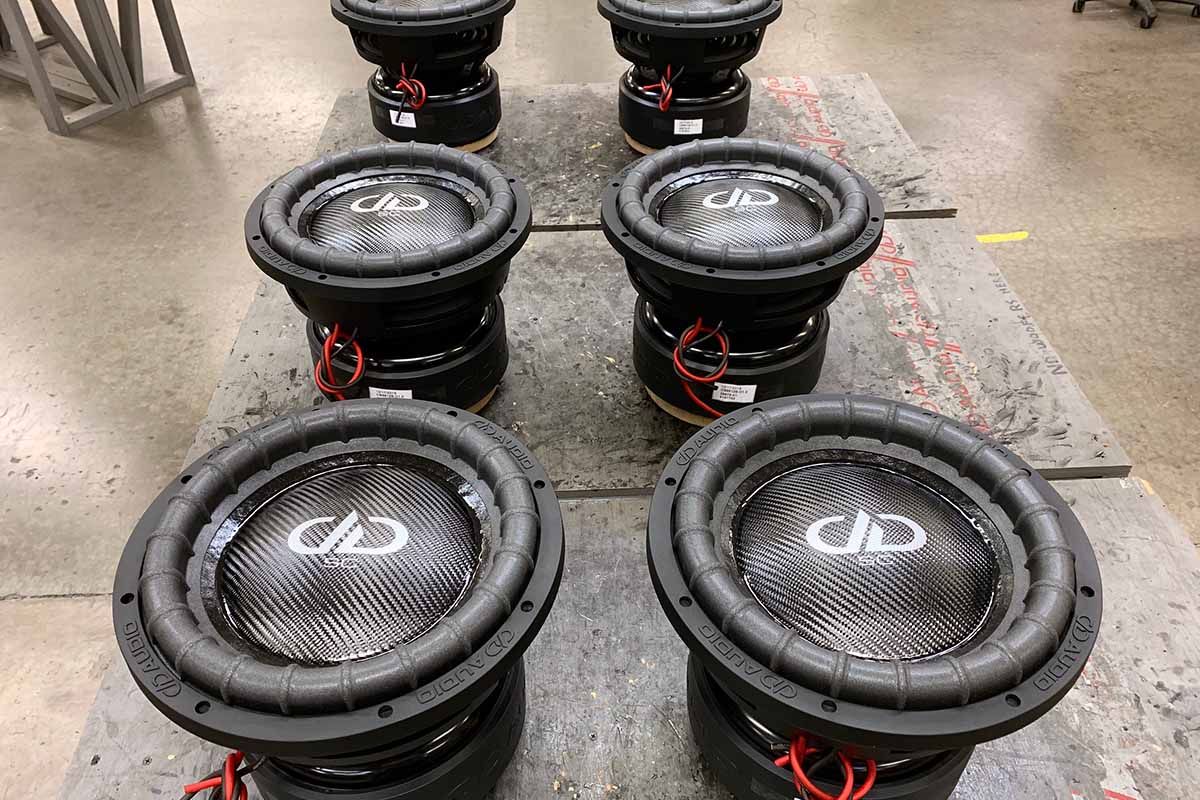 Six USA Made Subwoofers with black dust caps, white DDA logos, and white Super Charged decals