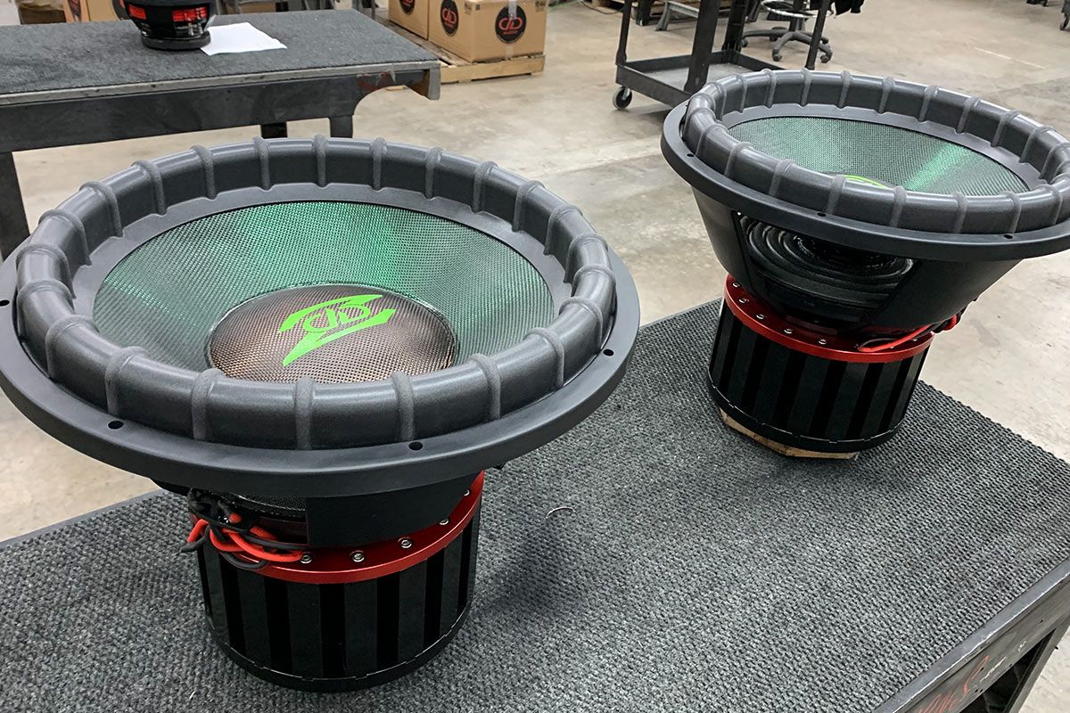 Two made in USA subwoofers with emerald green composite dust cone and copper orange dust caps and lime green ddz logos