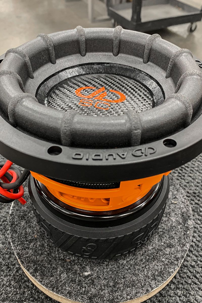 6 inch made in usa subwoofer with orange powder coated frame and black carbon fiber dust cap with paper cone and orange DD and supercharged logos