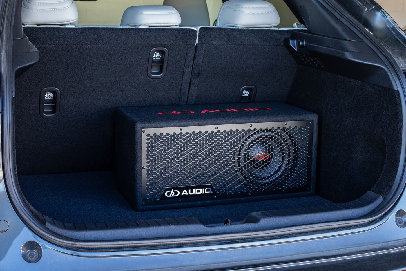 LE-508 8 inch loaded enclosure displayed in compact suv trunk with black carpet