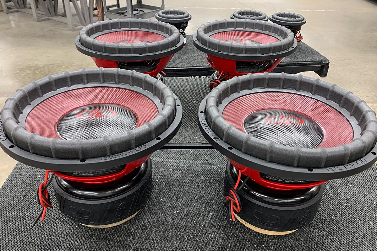 four made in usa subwoofers with red composite cone and black carbon fiber dust caps with red DD and supercharged logos