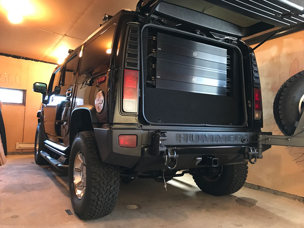 Hummer with the Rear Cargo Open to Show Amps