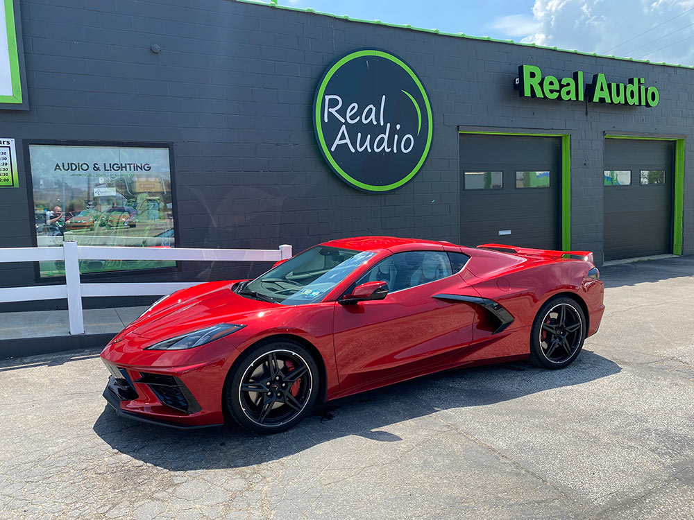 Picture of a new Corvette in front of shop